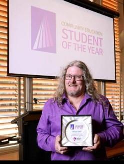 Grahame Neville receiving his award as the CCA 2022 Community Education Student of the year.